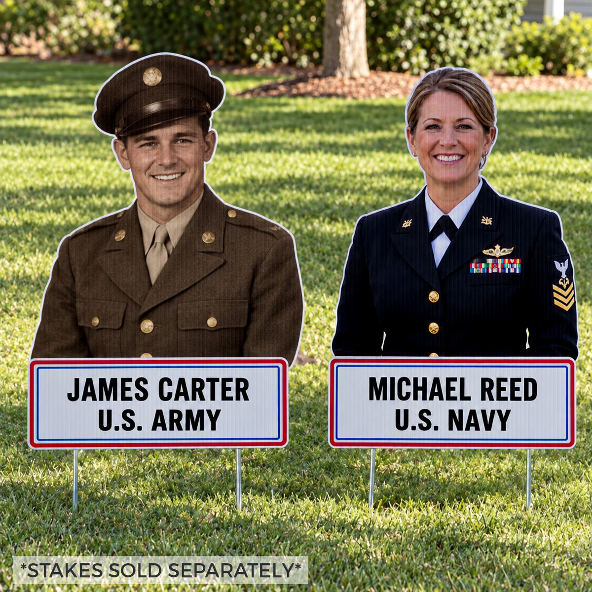 Two military-themed yard signs on metal stakes displayed on a grassy lawn. The left sign shows a portrait of a smiling man in a uniform.