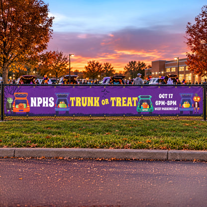 A purple Halloween event banner stretched across a chain-link fence in a parking lot at dusk. The banner reads 'NPHS TRUNK OR TREAT' with 'OCT 17 6PM-8PM' and 'WEST PARKING LOT' in white text, decorated with cartoon trick-or-treat vehicles and pumpkins.